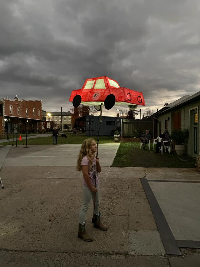 Girl holding a red car lantern